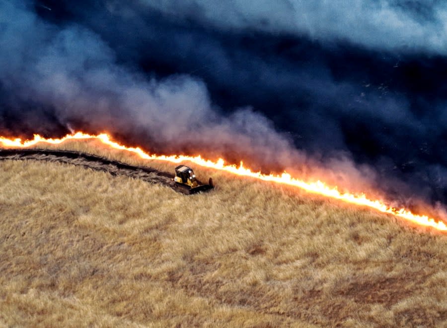 A dozer digs a firebreak line attempting to contain the Corral Fire. (Image courtesy Cal Fire SCU)