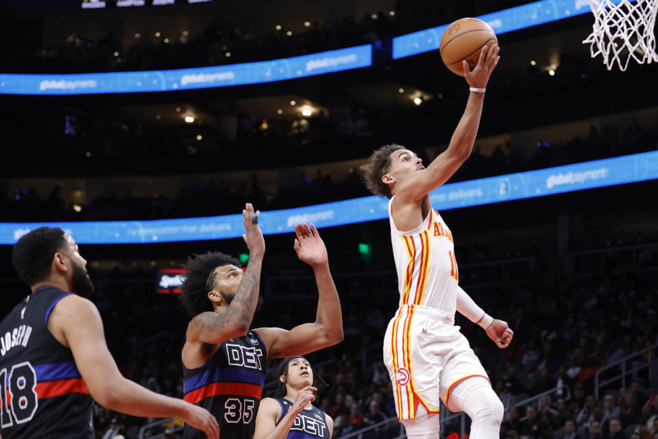 Atlanta Hawks guard Trae Young, right, shoots over Detroit Pistons guard Cory Joseph, left, forward Marvin Bagley III, second from left, and guard R.J. Hampton, second from right, during the first half of an NBA basketball game Tuesday, March 21, 2023, in Atlanta. (AP Photo/Alex Slitz)