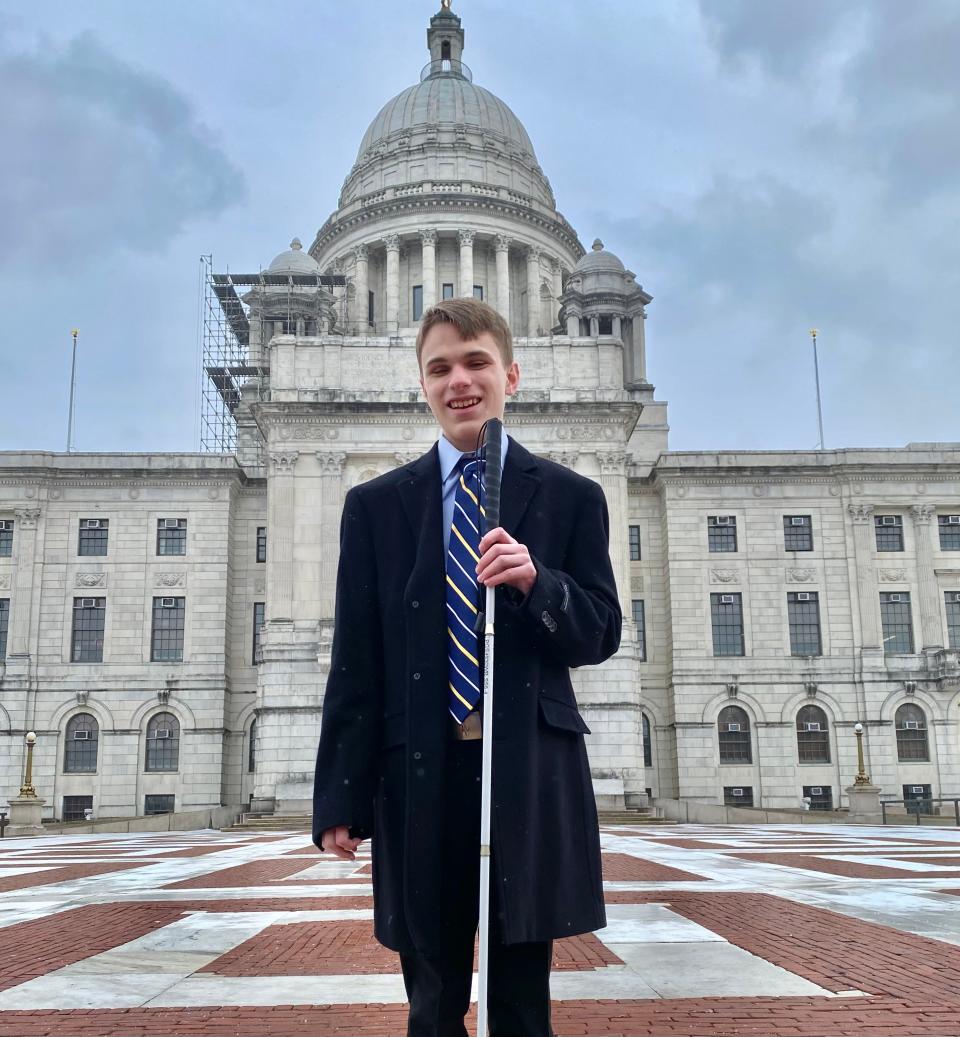 Ryan Lukowicz, the first blind page in the General Assembly, stands outside the Rhode Island State House.