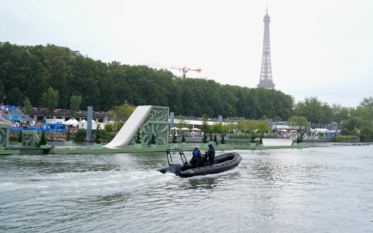 A police boat patrols the Seine ahead of the Opening Ceremony