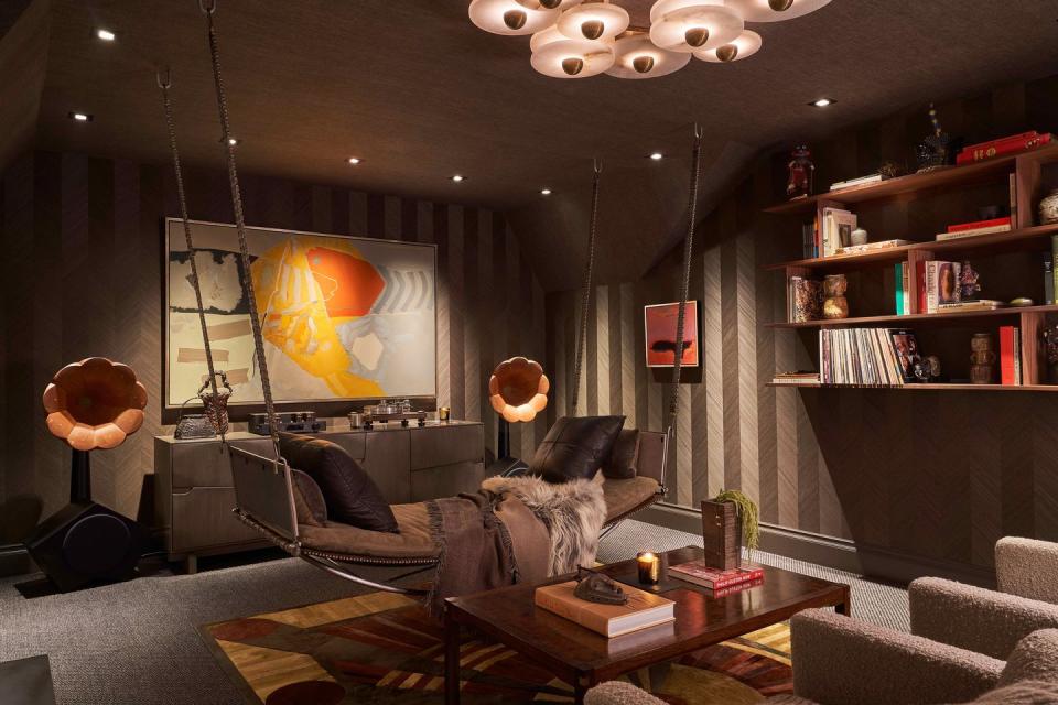 <p>Everything inside this media room by <a href="https://www.cravottainteriors.com/" rel="nofollow noopener" target="_blank" data-ylk="slk:Cravotta Interiors;elm:context_link;itc:0;sec:content-canvas" class="link ">Cravotta Interiors</a> was handmade, from the art and furniture to the rugs and the boutique audio gear. This is undoubtedly where you would take your friends to bond over good music and even better conversation, all aided by the moody dark linen ceiling, cerused wood walls, and deep umber sisal carpet. </p>