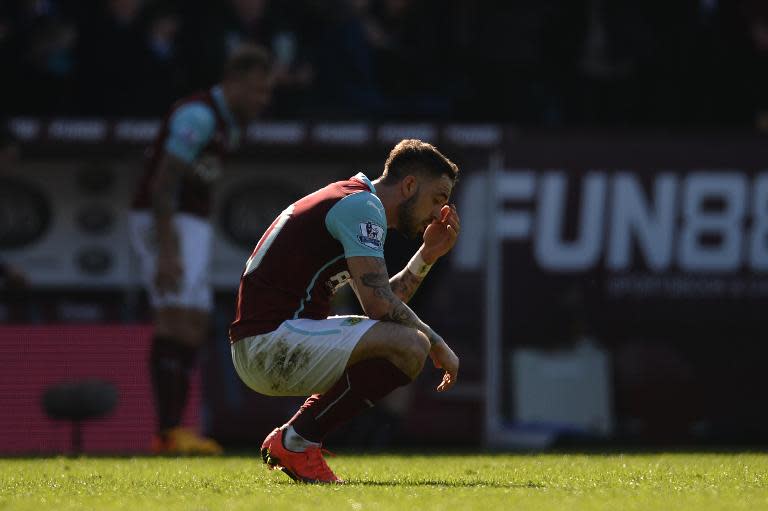 Burnley's striker Danny Ings crouches after the final whistle of the English Premier League football match in Burnley, England, on April 5, 2015