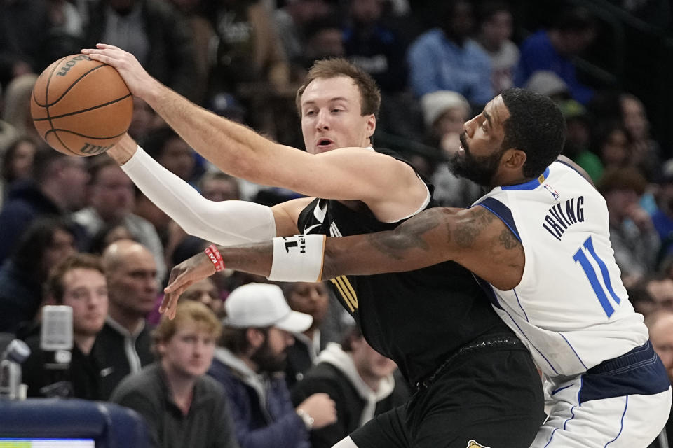 Memphis Grizzlies guard Luke Kennard (10) keeps the ball from Dallas Mavericks guard Kyrie Irving (11) during the second half of an NBA basketball game in Dallas, Tuesday, Jan. 9, 2024. (AP Photo/LM Otero)