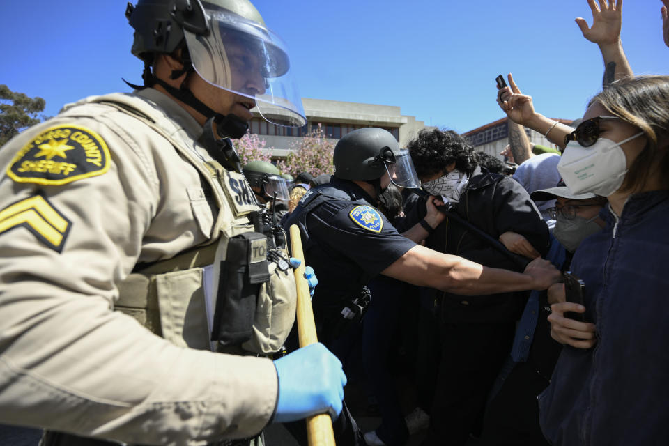 Police officers clash with Pro-Palestinian protesters at UC San Diego Monday, May 6, 2024, in San Diego. Police cleared a campus encampment in the early morning Monday. (AP Photo/Denis Poroy)