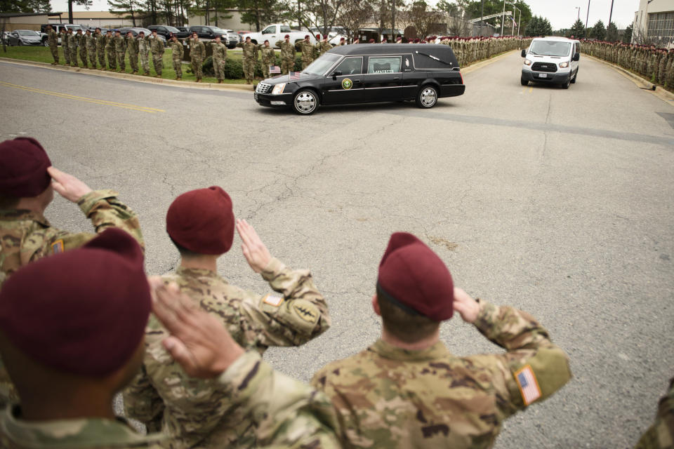 Soldiers salute as a hearse carrying the remains of Staff Sgt. Ian Paul McLaughlin drive by on Fort Bragg, N.C., on Saturday, Jan. 18, 2020. McLaughlin was killed Jan. 11 in Afghanistan. (Andrew Craft /The Fayetteville Observer via AP)