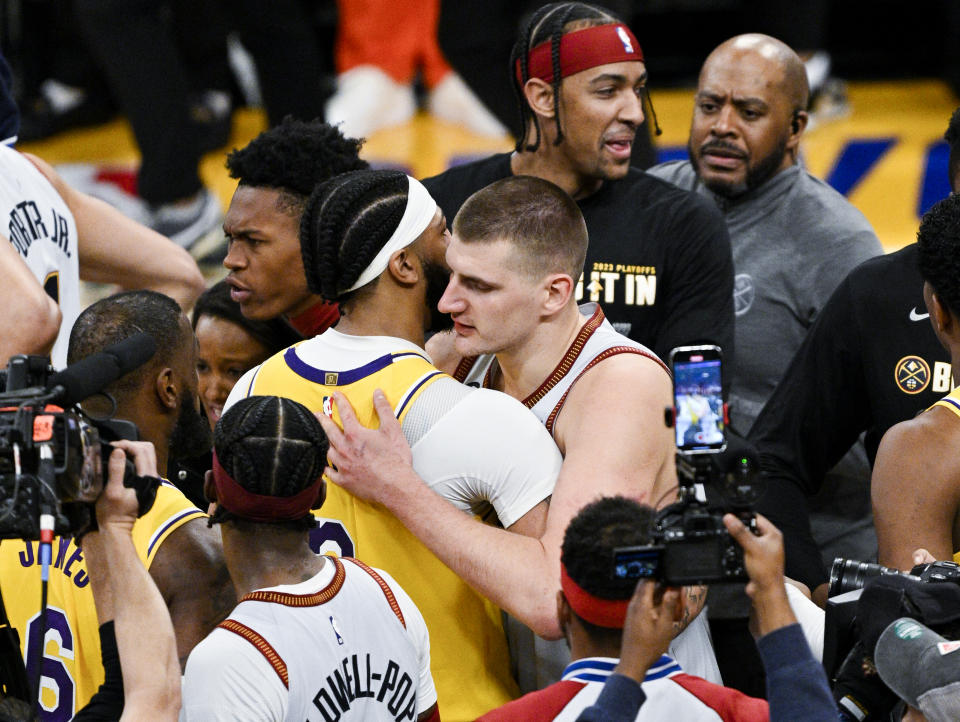 LOS ANGELES, CA - MAY 22: Los Angeles Lakers forward Anthony Davis, left, and Denver Nuggets center Nikola Jokic hug after game four in the NBA Playoffs Western Conference Finals at Crypto.com Arena on Monday, May 22, 2023 in Los Angeles, CA. (Gina Ferazzi / Los Angeles Times via Getty Images)