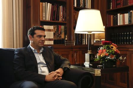 Alexis Tsipras, leader of Greece's far-left Syriza party listens to Greek President Karolos Papoulias (not pictured) during their meeting at the Presidential palace in Athens November 3, 2014. REUTERS/Yorgos Karahalis