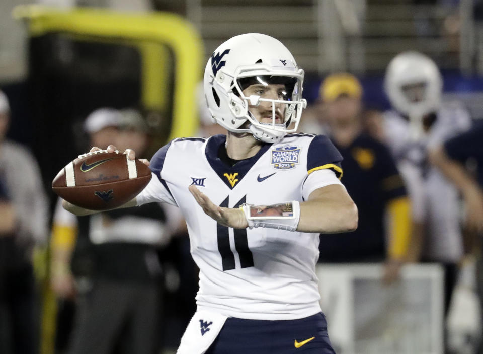 West Virginia quarterback Jack Allison looks for a receiver during the first half of the Camping World Bowl NCAA college football game against Syracuse, Friday, Dec. 28, 2018, in Orlando, Fla. (AP Photo/John Raoux)