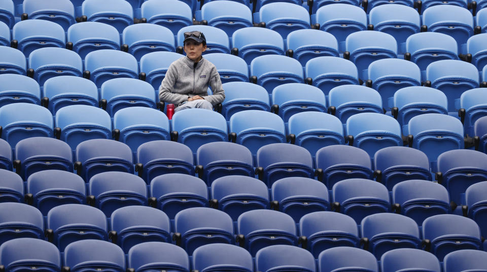 A spectator watches the first round match between Russia's Anastasia Pavlyuchenkova and Japan's Naomi Osaka on Rod Laver Arena at the Australian Open tennis championship in Melbourne, Australia, Monday, Feb. 8, 2021.(AP Photo/Rick Rycroft)