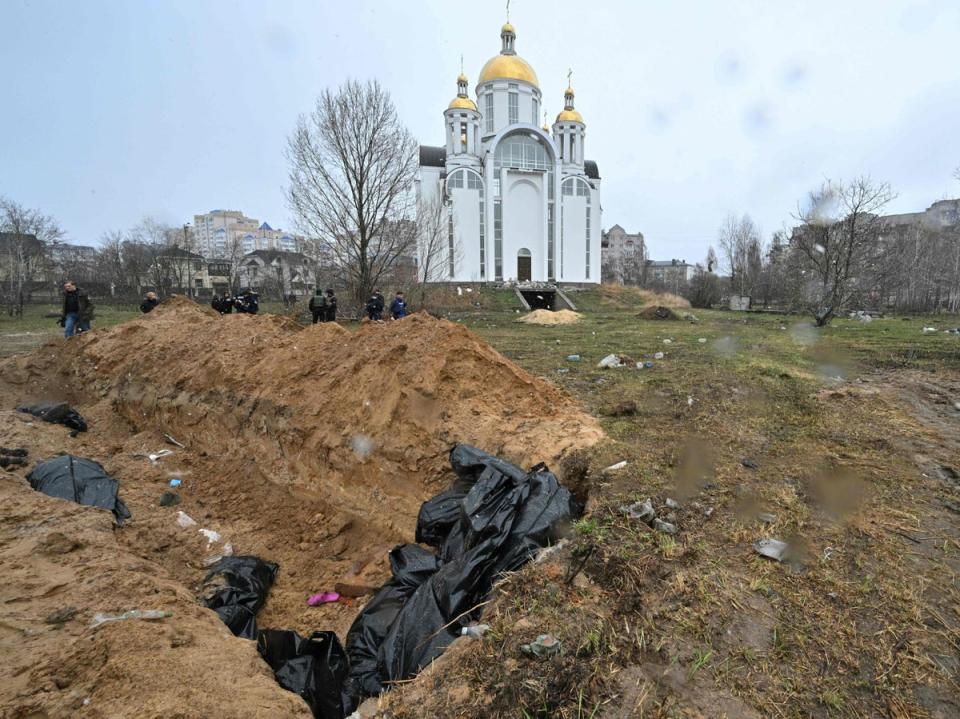 A mass grave is seen behind a church in the town of Bucha on 3 April (AFP/Getty)