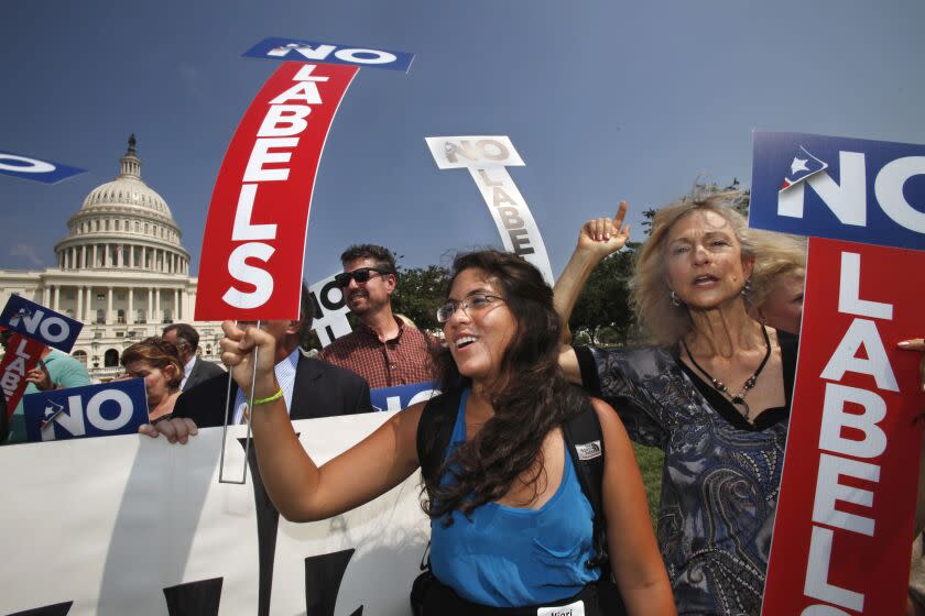 Iliari Gutierrez, of Damascus, Md., center, and Lynne Monds, of Santa Barbara, Calif., rally with the group "No Labels", on Capitol Hill in Washington, Monday, July 18, 2011, to urge Congress and the president to find a bipartisan solution to the fiscal crisis. (AP Photo/Jacquelyn Martin)