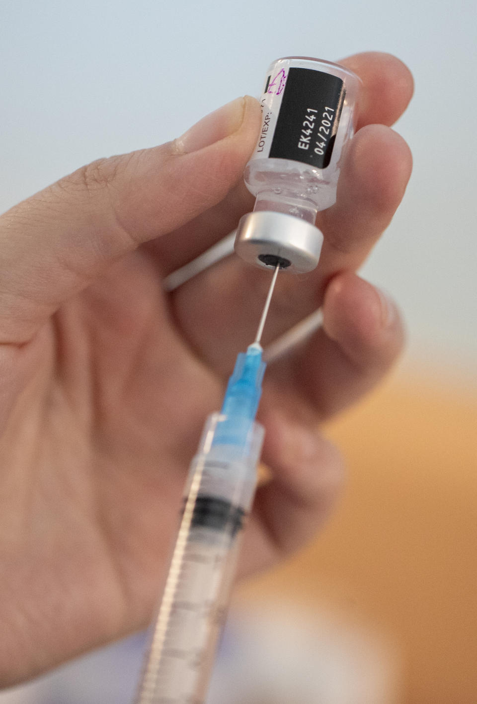 A nurse prepares a COVID-19 vaccine shot for a health worker at the Posta Central Hospital in Santiago, Chile, Thursday, Dec. 24, 2020, on the same day the first shipment of vaccines from Pfizer and its German partner, BioNTech, arrived to Chile. (AP Photo/Esteban Felix)
