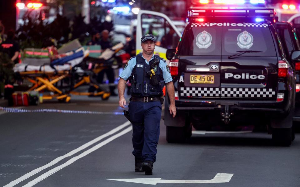 A police officer reacts outside the Westfield Bondi Junction shopping centre