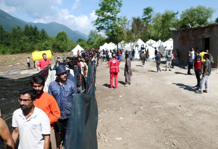 Migrants wait for food and clothes at the migrant camp Vucjak in Bihac area