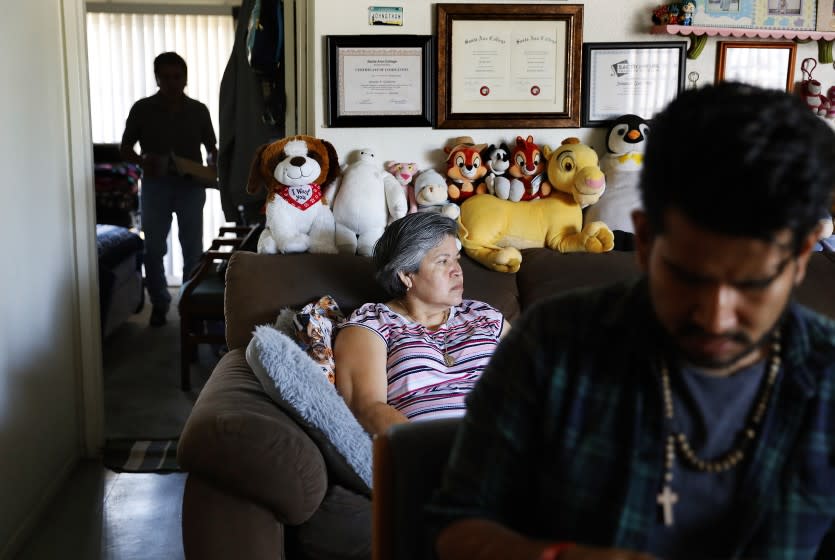 SANTA ANA, CALIFORNIA: Jonatan Gutierrez, 32, right, and his parents Rocio Urzua, 54, center, and Pablo Gutierrez, 65, at left, are photographed at home in Santa Ana, California on Friday, July 2, 2021. Medi-Cal expansion will offer relier to income eligible adults 50 and older regardless of immigration status. (Christina House / Los Angeles Times)