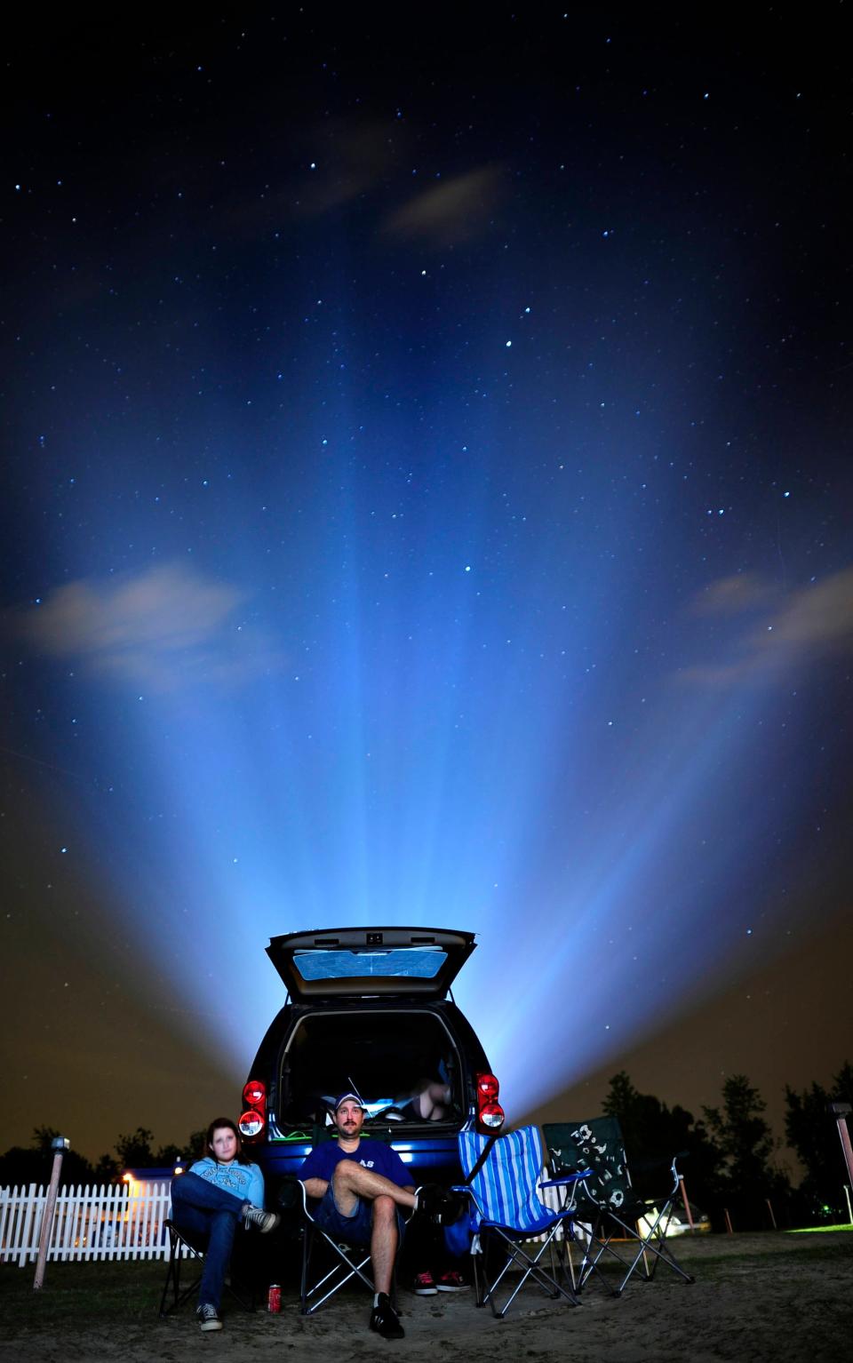 FILE - A movie is projected from behind movie goers at the Big Mo Drive-In, which is open Fridays-Sundays.