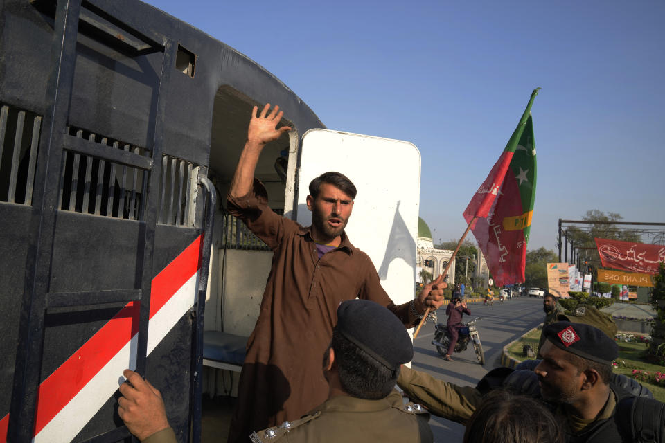 Police officers detain a supporter of Pakistan's former Prime Minister Imran Khan during a clash, in Lahore, Pakistan, Wednesday, March 8, 2023. Pakistani police used water cannons and fired tear gas to disperse supporters of the country's former Prime Minister Khan Wednesday in the eastern city of Lahore. Two dozen Khan supporters were arrested for defying a government ban on holding rallies, police said. (AP Photo/K.M. Chaudary)