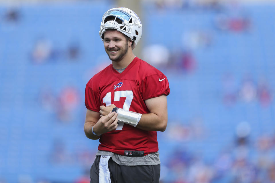 Buffalo Bills quarterback Josh Allen (17) smiles during practice at NFL football training camp in Orchard Park, N.Y., on Saturday, July 31, 2021. (AP Photo/Joshua Bessex)