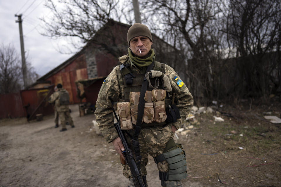 A soldier smokes a cigarette near the frontline in Brovary, on the outskirts of Kyiv, Ukraine, Monday, March 28, 2022. (AP Photo/Rodrigo Abd)