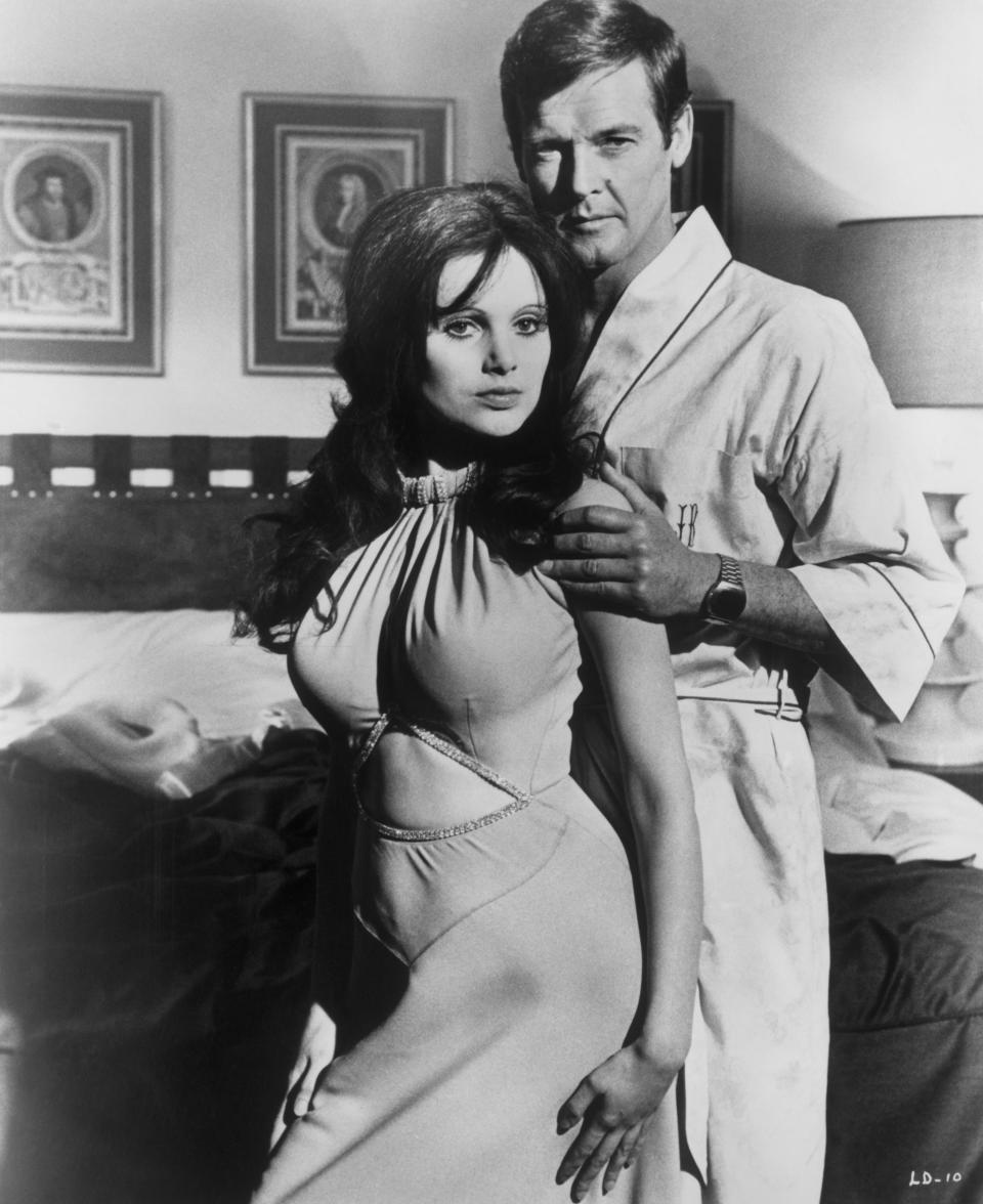 Madeline Smith and Roger Moore on the set of Bond's flat in Live and Let Die (United Archives via Getty Images)