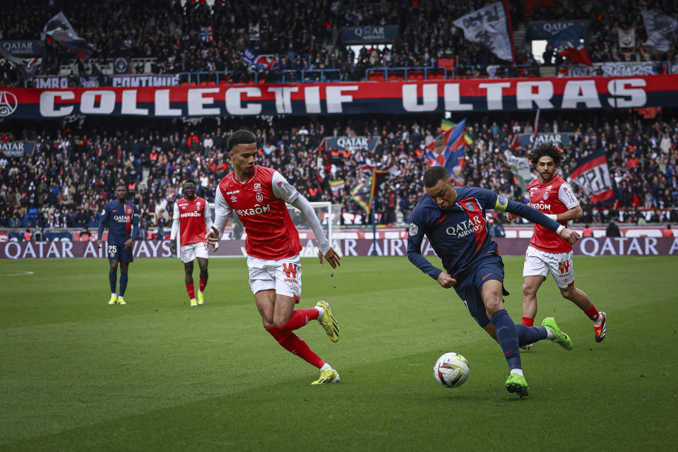 PSG's Kylian Mbappe, right, and Reims' Amir Richardson fight for the ball during the French League One soccer match between Paris Saint-Germain and Reims at the Parc des Princes stadium in Paris, France, Sunday, March 10, 2024. (AP Photo/Aurelien Morissard)