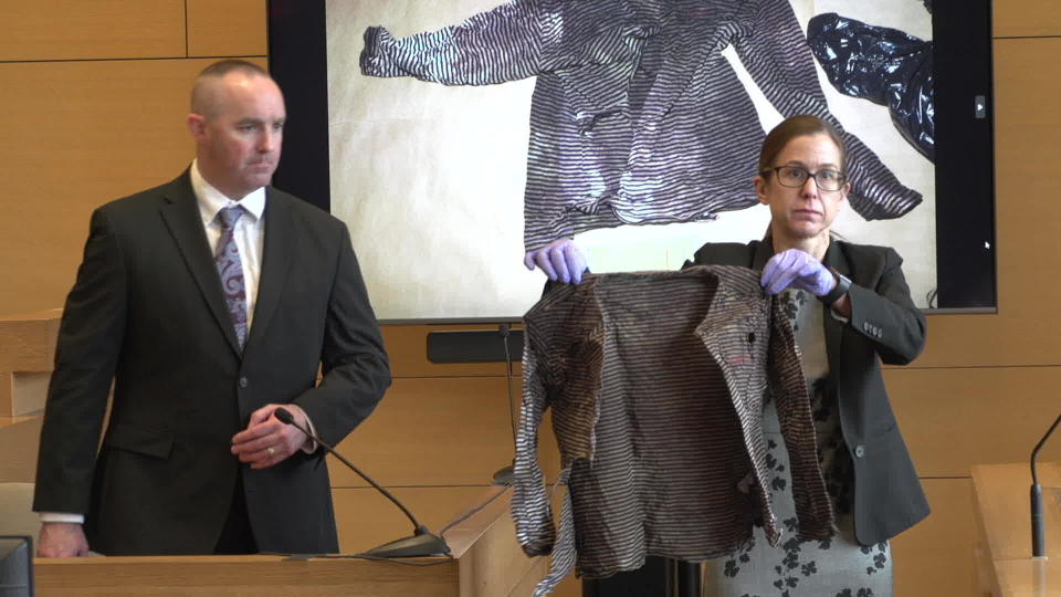 At trial, Prosecutor Michelle Manning holds up a bloody shirt belonging to Jennifer Dulos. / Credit: Pool