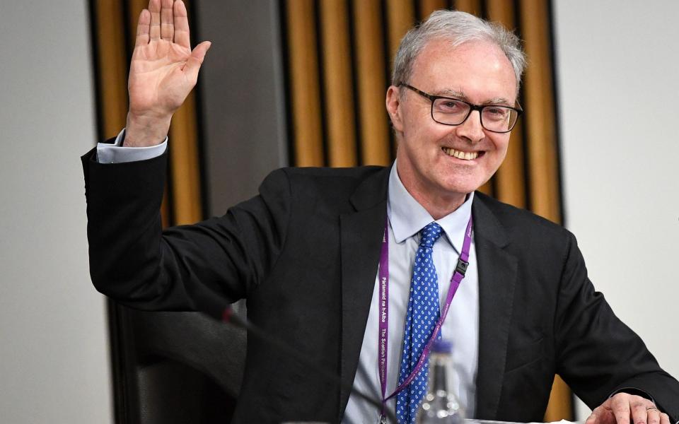 Lord Advocate James Wolffe is sworn in to give evidence to a Scottish Parliament committee at Holyrood in Edinburgh - AFP