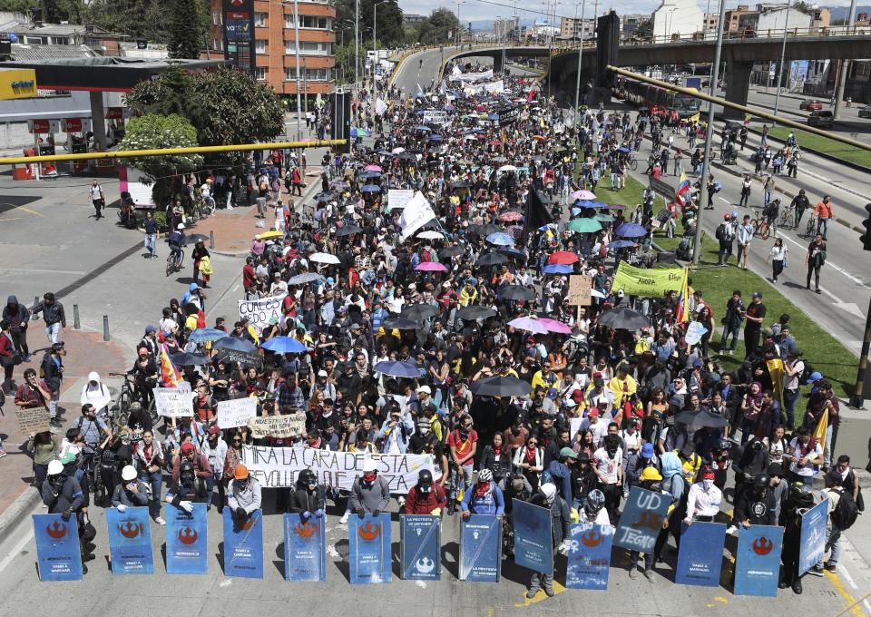 Anti-government demonstrators march during a national strike in Bogota, Colombia, Wednesday, Dec. 4, 2019. Colombia’s recent wave of demonstrations began with a massive strike on Nov. 21 that drew an estimated 250,000 people to the streets. Protests have continued in the days since but at a much smaller scale. (AP Photo/Fernando Vergara)