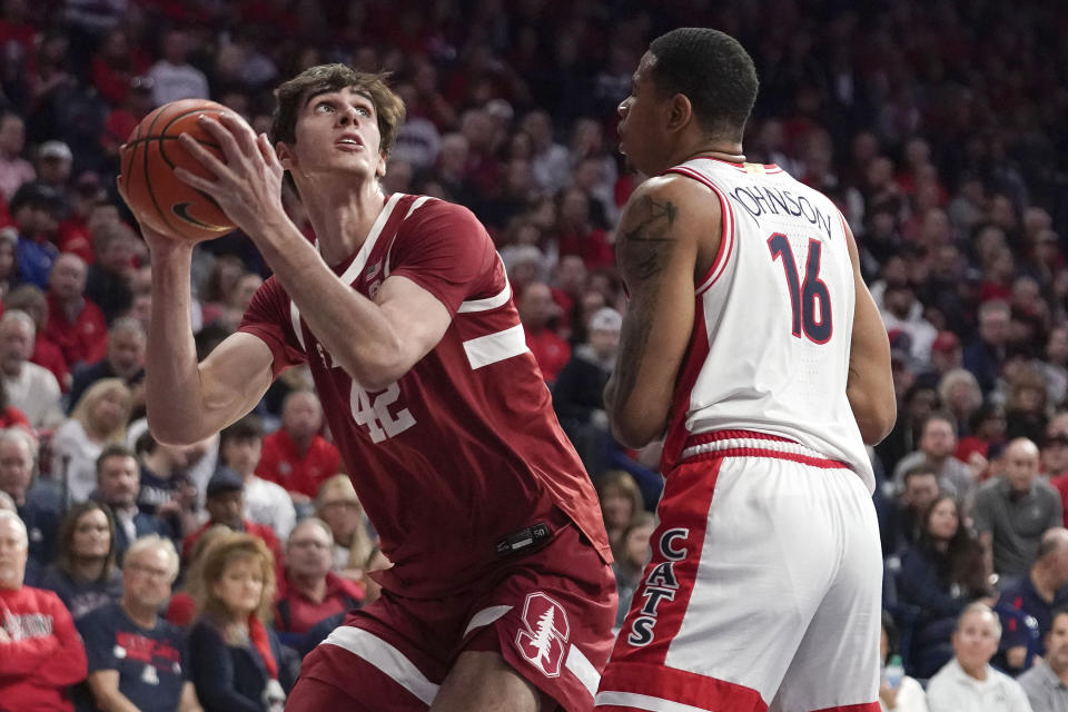 Stanford's Maxime Raynaud (42) looks to the basket against Arizona's Keshad Johnson (16) during the first half of an NCAA college basketball game Sunday, Feb. 4, 2024, in Tucson, Ariz. (AP Photo/Darryl Webb)