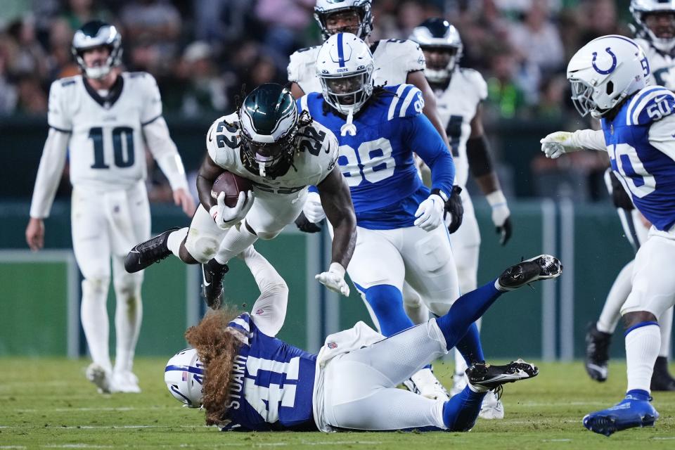 Philadelphia Eagles running back Trey Sermon (22) falls over Indianapolis Colts linebacker Grant Stuard (41) during the first half of an NFL preseason football game Thursday, Aug. 24, 2023, in Philadelphia. (AP Photo/Matt Rourke)