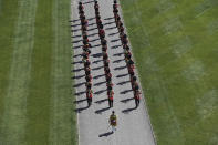 Members of a military band march into the Quadrangle at Windsor Castle in Windsor, England Saturday, April 17, 2021 ahead of the funeral of Britain's Prince Philip. Prince Philip died April 9 at the age of 99 after 73 years of marriage to Britain's Queen Elizabeth II.(Kirsty O'Connor/Pool via AP)