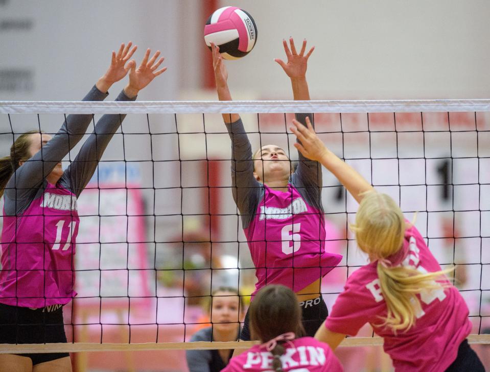 Morton's Graci Junis (6) and Kylie Berg (11) try to block a spike from Pekin's Graci Guenther during their volleball match Thursday, Oct. 6, 2022 at Pekin Community High School. The Dragons defeated the Potters in three sets 25-23, 25-17 and 25-20.