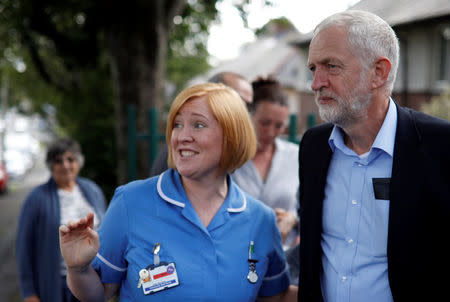 Britain's opposition Labour party leader, Jeremy Corbyn, speaks to a nurse during a visit to the Hope Centre in Bolton, Britain August 17, 2017. REUTERS/Phil Noble