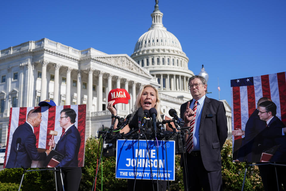Rep. Marjorie Taylor Greene, R-Ga., joined by Rep. Thomas Massie, R-Ky., says she'll call a vote next week on ousting House Speaker Mike Johnson, R-La., during a news conference at the Capitol in Washington, Wednesday, May 1, 2024. Rep. Greene, a staunch ally of former President Donald Trump, is forcing her colleagues to choose sides after Democratic leaders announced they'd provide the votes to save the Republican speaker's job. (AP Photo/J. Scott Applewhite)