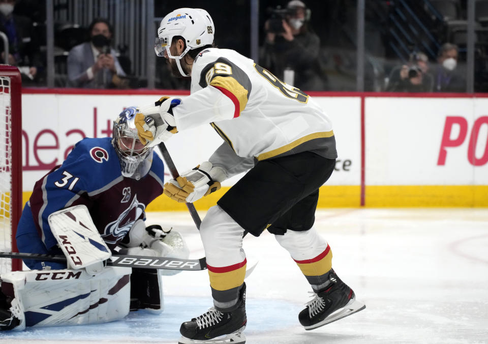 Vegas Golden Knights right wing Alex Tuch, right, scores a goal past Colorado Avalanche goaltender Philipp Grubauer in the third period of Game 5 of an NHL hockey Stanley Cup second-round playoff series Tuesday, June 8, 2021, in Denver. (AP Photo/David Zalubowski)