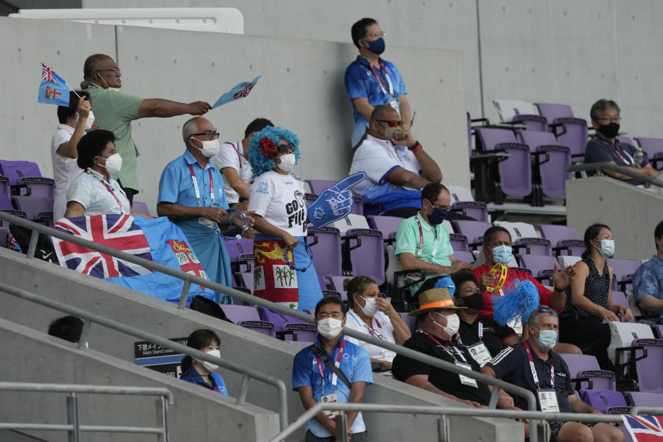 Supporters of Fiji wave flags in the stands during the women's rugby bronze medal match between Fiji and Britain at the 2020 Summer Olympics, Saturday, July 31, 2021 in Tokyo, Japan. (AP Photo/Shuji Kajiyama)