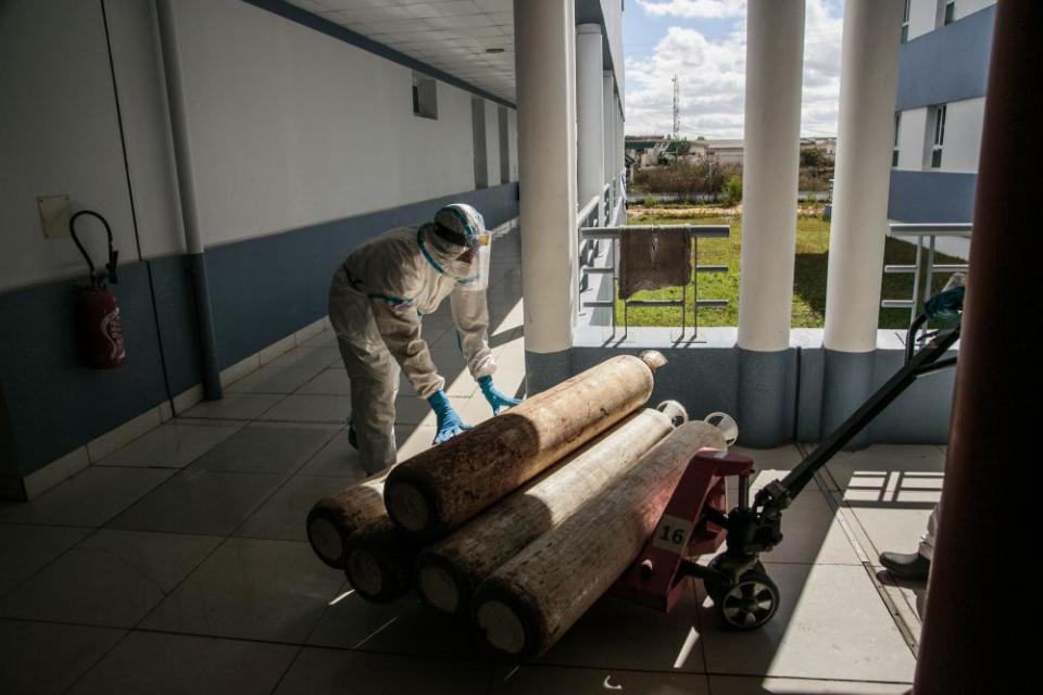 Health personnel move oxygen cylinders for the most severely affected coronavirus patients at the Andohatapenaka University hospital in Antananarivo, Madagascar.