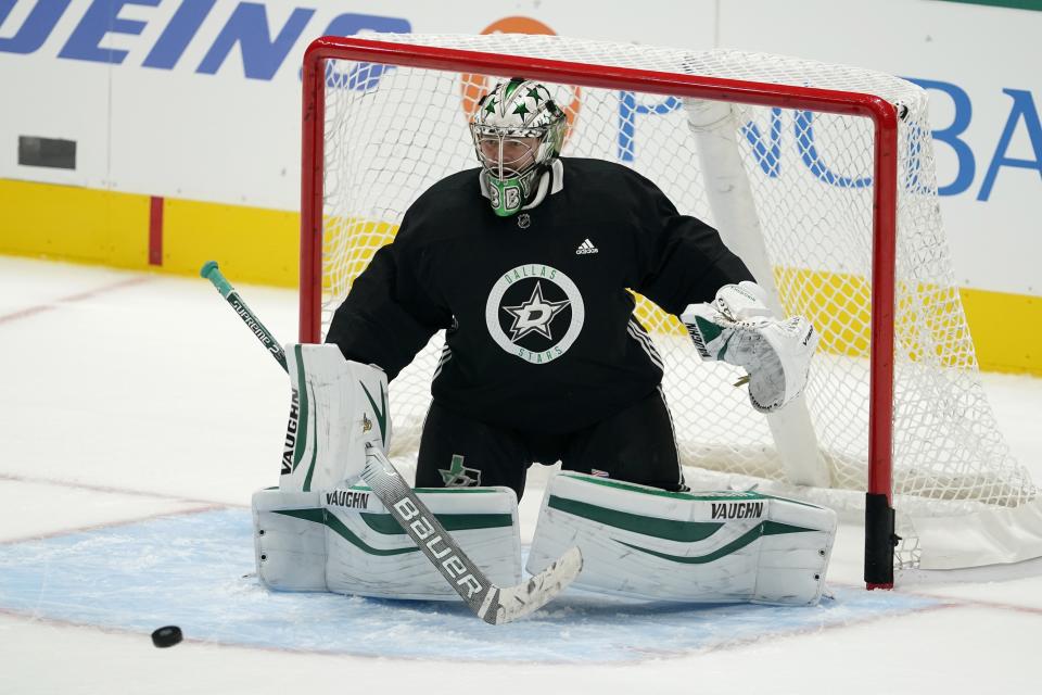 Dallas Stars goalie Anton Khudobin defends against a shot during NHL hockey practice in Dallas, Thursday, Jan. 21, 2021. (AP Photo/Tony Gutierrez)