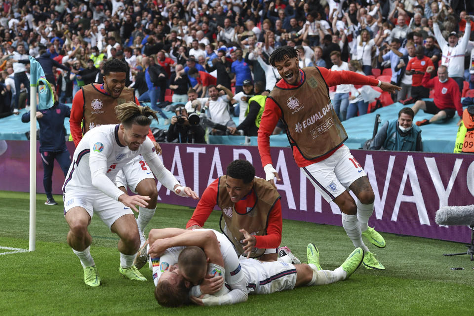 England's Harry Kane, bottom, is celebrated by teammates after scoring his side's 2nd goal the Euro 2020 soccer championship round of 16 match between England and Germany, at Wembley stadium in London, Tuesday, June 29, 2021. England won 2-0. (Andy Rain, Pool via AP)