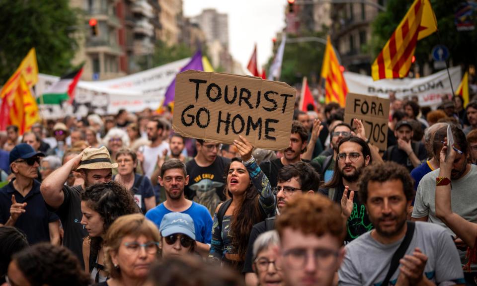 <span>Demonstrators march in Barcelona in June 2024 against growing overtourism in the Catalan city, which is affecting local people.</span><span>Photograph: Emilio Morenatti/AP</span>