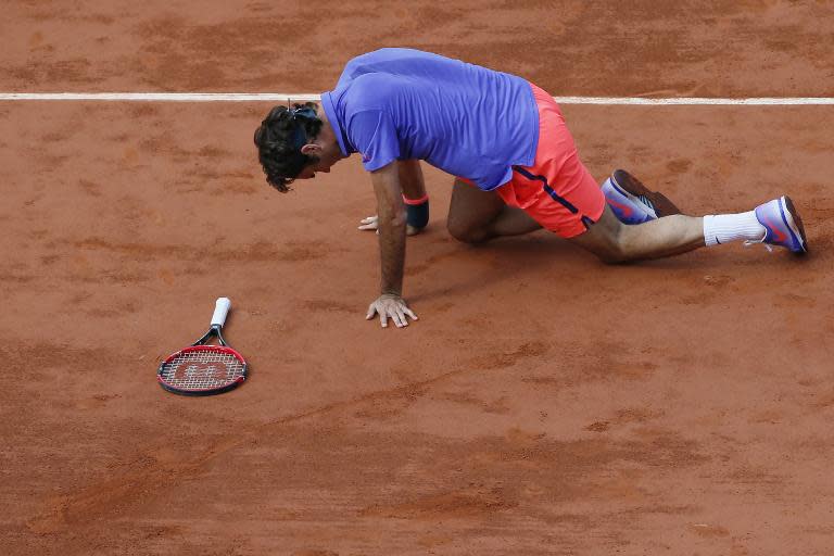 Switzerland's Roger Federer is pictured after falling down during his men's quarter final match against Switzerland's Stanislas Wawrinka at the Roland Garros 2015 French Tennis Open in Paris on June 2, 2015