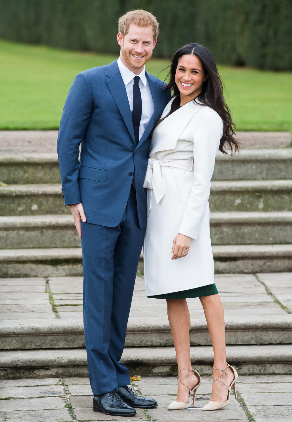 To announce her engagement to Prince Harry, Meghan Markle wore an emerald-green dress under her white coat. (Photo: Getty Images)