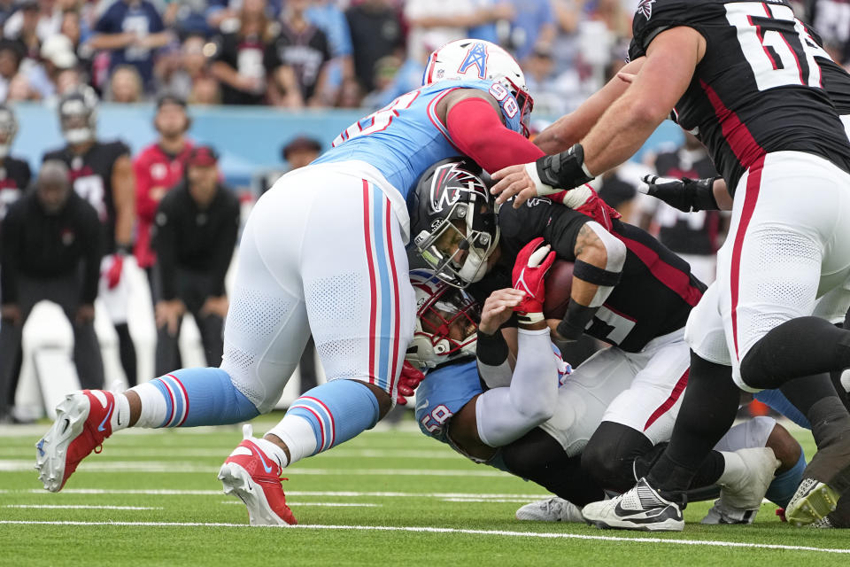 Atlanta Falcons quarterback Desmond Ridder (9) is sacked by Tennessee Titans linebacker Harold Landry III (58) and defensive tackle Jeffery Simmons (98) during the first half of an NFL football game, Sunday, Oct. 29, 2023, in Nashville, Tenn. (AP Photo/George Walker IV)