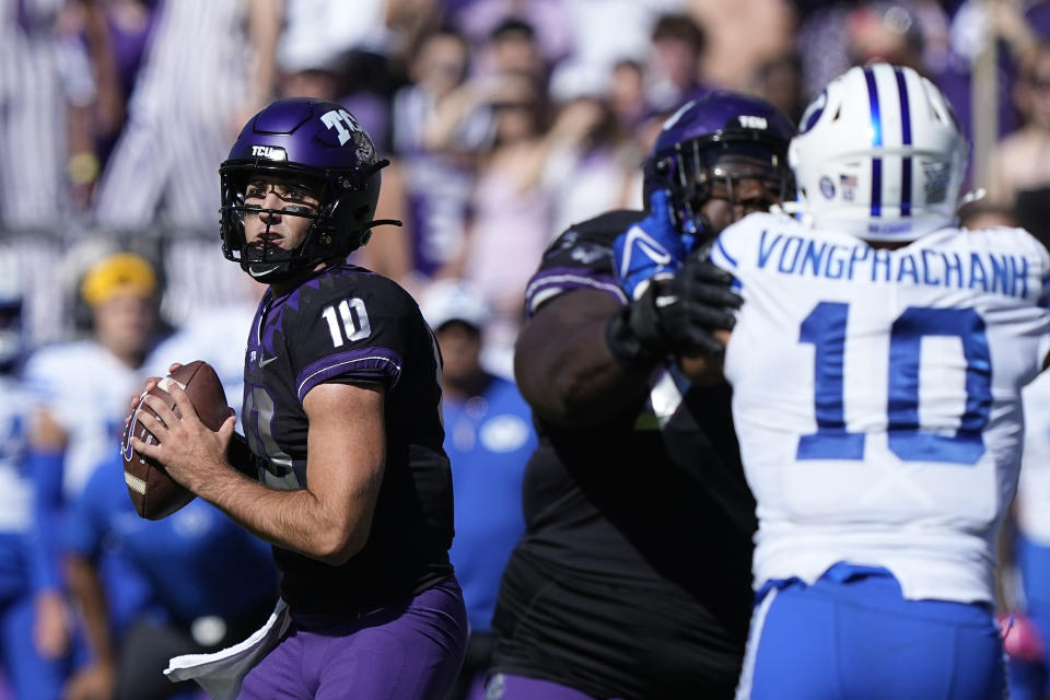 TCU quarterback Josh Hoover (10) looks to pass with blocking against BYU linebacker AJ Vongphachanh (10) during the first half of an NCAA college football game Saturday, Oct. 14, 2023, in Fort Worth, Texas. (AP Photo/LM Otero)