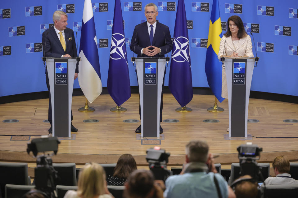 Finland's Foreign Minister Pekka Haavisto, left, Sweden's Foreign Minister Ann Linde, right, and NATO Secretary General Jens Stoltenberg attend a media conference after the signature of the NATO Accession Protocols for Finland and Sweden in the NATO headquarters in Brussels, Tuesday, July 5, 2022. (AP Photo/Olivier Matthys)