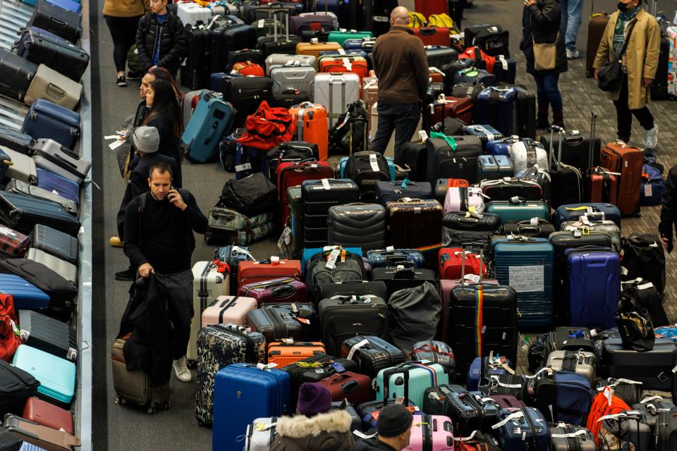 Luggage bags are amassed in the bag claim area at Toronto Pearson International Airport, as a major winter storm disrupts flights in and out of the airport, in Toronto, Saturday, Dec. 24, 2022 (AP)