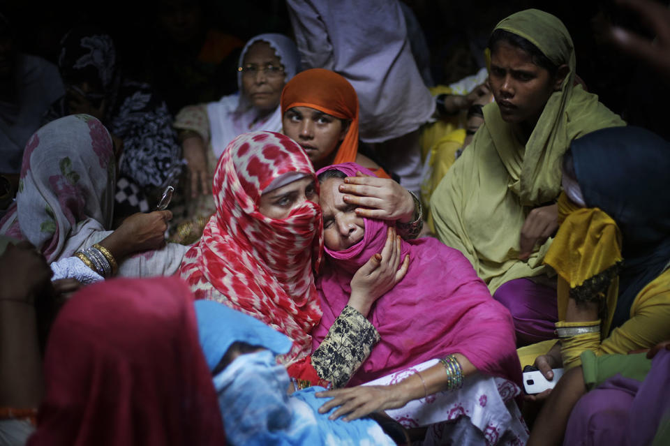 Woman comforts the mother of man killed by a gang