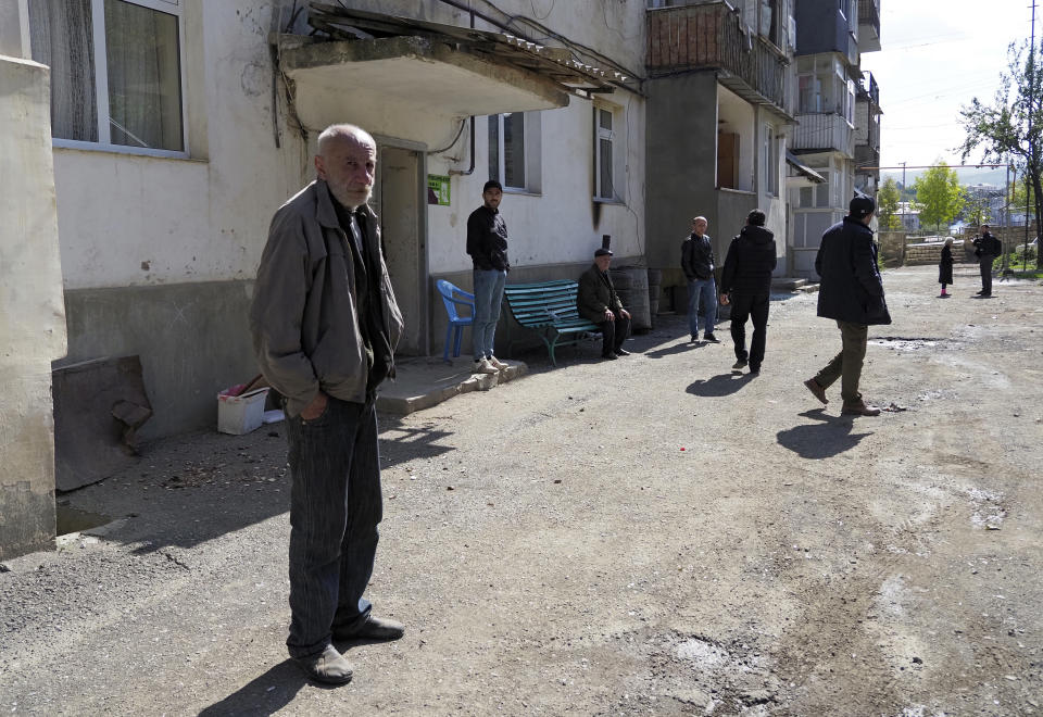 People come out from the basement of their apartment building after beginning of the cease-fire during a military conflict in Stepanakert, the separatist region of Nagorno-Karabakh, Saturday, Oct. 10, 2020. Armenia and Azerbaijan have agreed to a Russia-brokered cease-fire in Nagorno-Karabakh after two weeks of heavy fighting that marked the worst outbreak of hostilities in the separatist region in more than a quarter-century. (AP Photo)