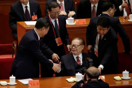 President Xi Jinping (L) shakes hands with former President Jiang Zemin after the opening. REUTERS/Jason Lee