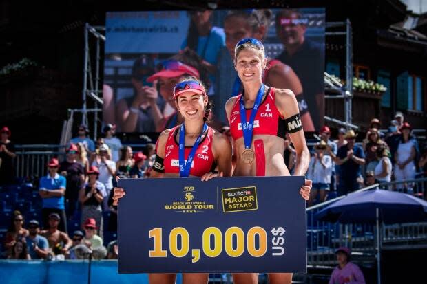 Melissa Humana-Paredes, left, and Sarah Pavan pose after winning the bronze-medal match at the FIVB World Tour event in Gstaad, Switzerland, on Sunday. (FIVB - image credit)